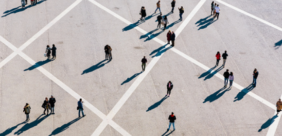 Aerial view of a group of people in an empty parking lot.